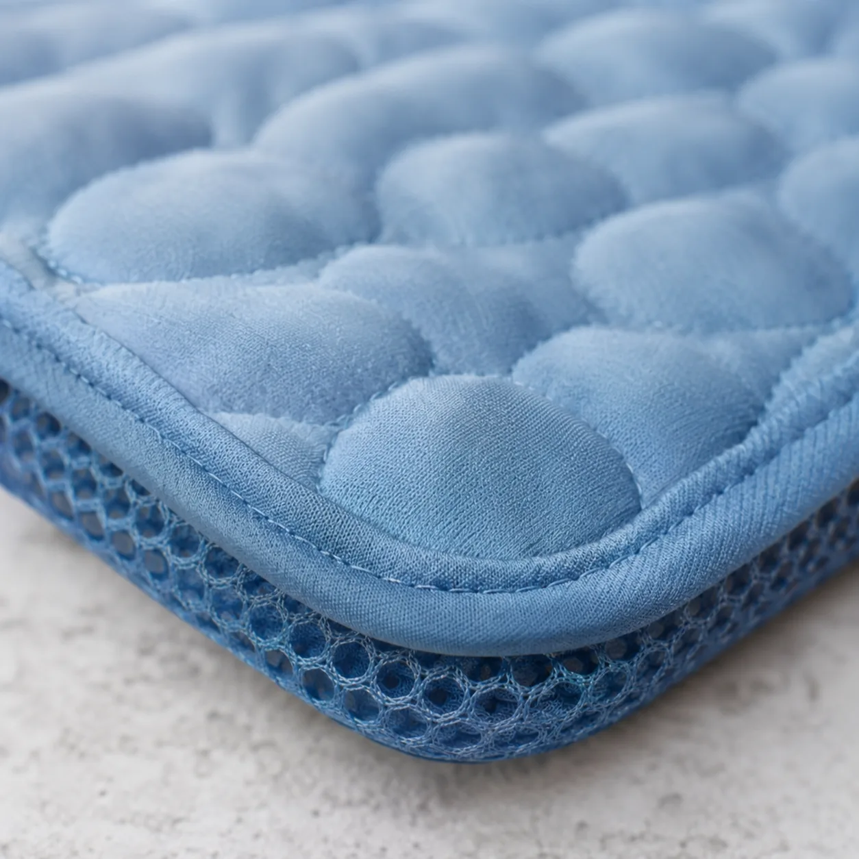 Macro shot of the Frimouf cooling mat: quilted ice silk on top and breathable mesh visible along the edge